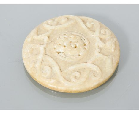 CHINESE JADE CIRCULAR DISC
with relief decoration and pierced centre, 7cm diameter 