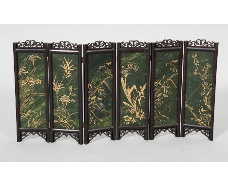 CHINESE GREEN HARDSTONE TABLE SCREEN
with floral decoration in gilt, of six panels, overall height 36cm, each panel 12cm wide