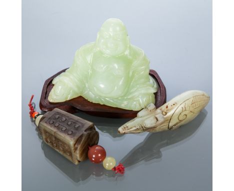 JADE FIGURE OF BUDDHA 
over shaped wooden stand; together with another hardstone carved figure and a jade amulet (3)