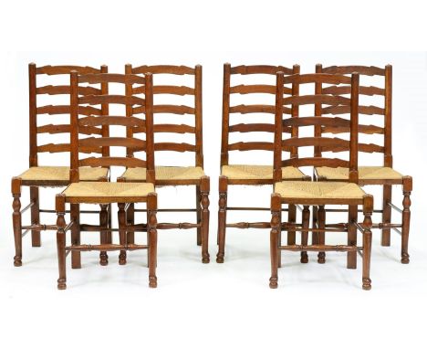 A set of six rush seated stained ash ladder back chairs, 20th c  Good condition