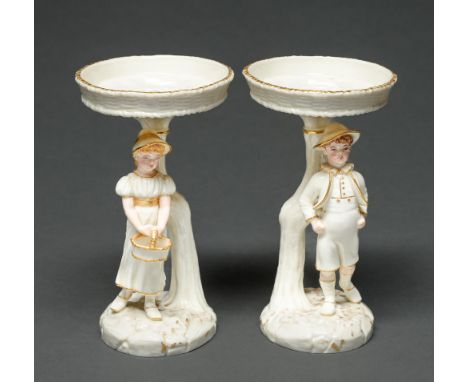 A pair of Royal Worcester single boy and girl early English comports, 1883,&nbsp;designed by James Hadley in the manner of Ka