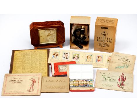 An Elliott amboyna mantel clock,&nbsp; 15cm h, a cased set of English regional maps, a boxed student's&nbsp;microscope and se