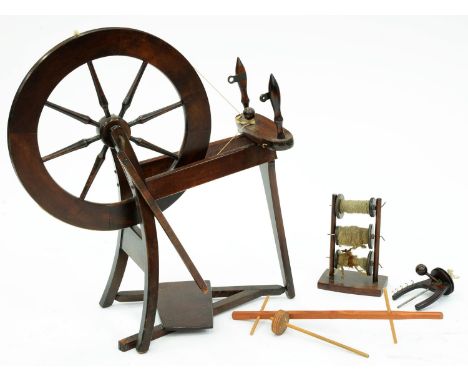 A mahogany and mahogany-stained wood spinning wheel, first half 20th c, wheel 54cm diam  Basically complete and in good condi