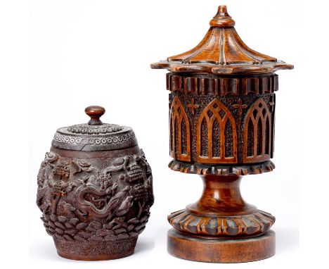 A Victorian gothic lead lined oak tobacco jar and cover and a Chinese barrel shaped and brass lined carved wood tobacco jar a