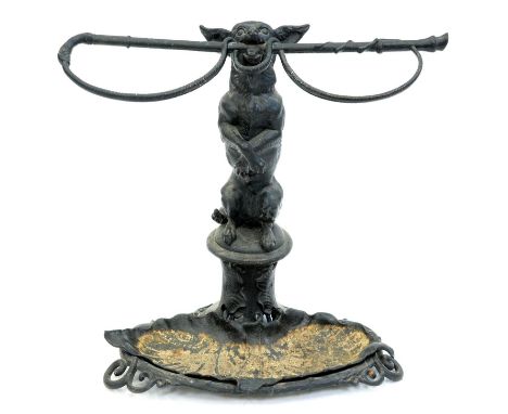 A cast iron begging dog and riding crop umbrella stand, first half 20th c, with detachable leafy naturalistic drip tray, 60cm