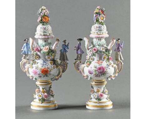 A pair of Meissen floral encrusted vases and covers, late 19th c, with diminutive figure handles in the form of a lady with a