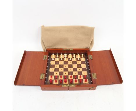 A late 19th/early 20th century Whittington style travelling chess set, stained red and white carved bone pieces, in folding m