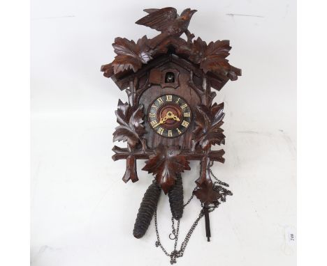 A Vintage Black Forest oak cuckoo clock, with pine cone weights, clock height 45cm 