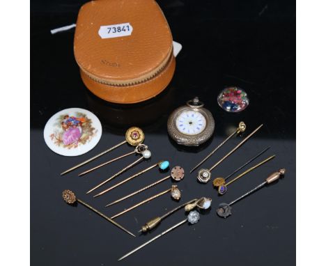 An unmarked yellow metal and amethyst set stickpin, an engraved Continental silver fob watch with enamel dial, and gold and o