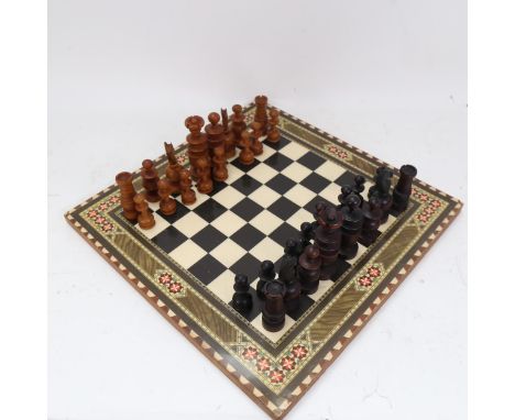 A turned wood chess set, on board with inlaid decoration, King height 9.5cm 