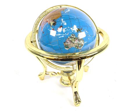 A reproduction brass and hardstone table-top terrestrial globe, with compass inset base, overall height 33cm, globe diameter 