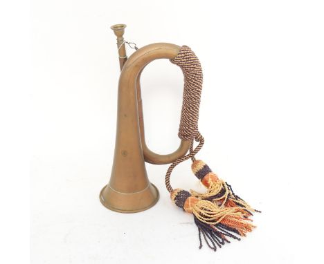 A First World War Period brass bugle, with rope tassels 