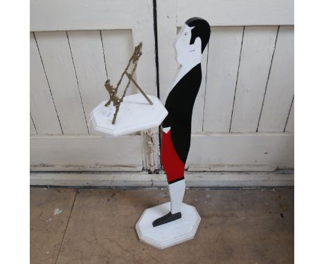 A painted plywood dumb waiter, holding small brass easel, figure height 90cm 