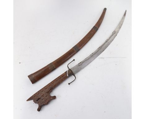 A Middle Eastern/Persian curved sword, with chip carved wood handle and scabbard, blade length 39cm 