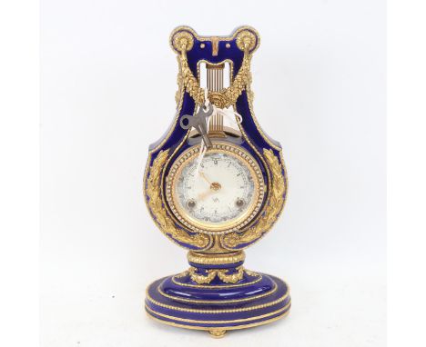 A replica Marie-Antoinette clock from the Victoria & Albert Museum, gilded blue glaze porcelain in lyre form, height 36cm, wi