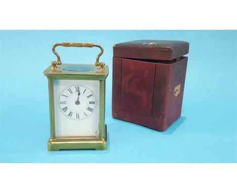 A small brass carriage clock and leather case.  10.5cm high