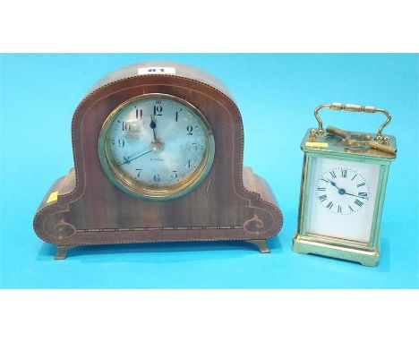 A small carriage clock and an Edwardian mantel clock.