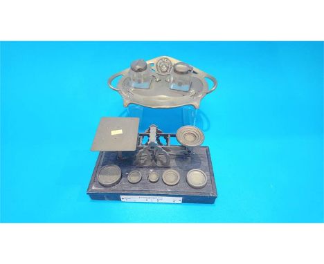An Art Nouveau shaped brass inkwell and a set of scales.