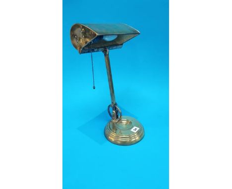 A brass desk lamp with pull switch.