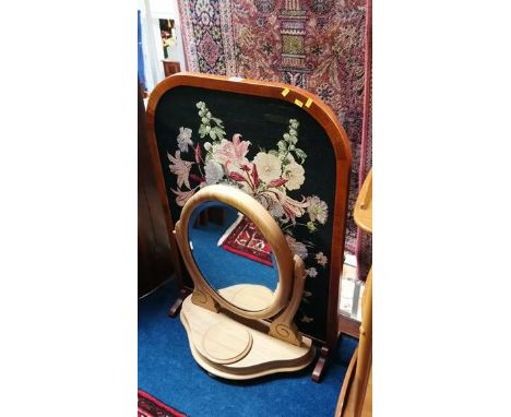A needlework fire screen and a dressing table mirror.