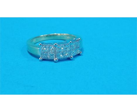 An 18ct gold ring set with twelve diamonds, set in groups of four.  Approx. 1.2cts
