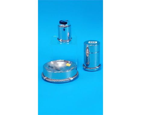 A Gucci metal ashtray with rope twist decoration, a Gucci cigarette case and table lighter.