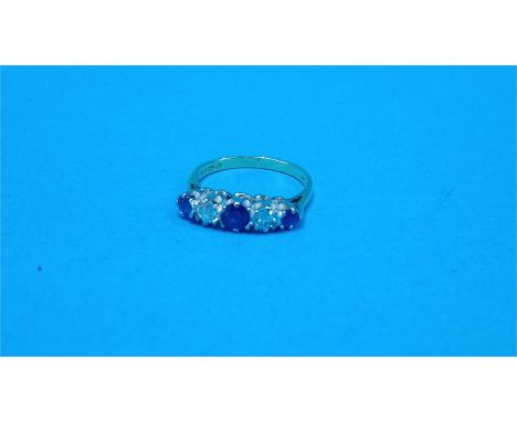 An 18ct gold ring set with three sapphires and two diamonds.