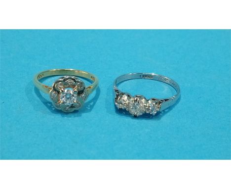 An 18ct gold diamond cluster ring and a platinum diamond three stone ring.