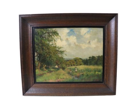 Joseph Barnard Davis (1861-1943) An impressionistic depiction of two young children playing in a meadow framed by woodland, o