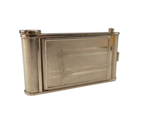 A mid-20th-Century combination powder compact and grooming kit in the form of a roll film camera, faux-engine turned decorate