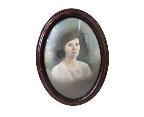 A portrait of a 1920s lady in period dress with her visage based on a portrait photograph, dated 1925 verso, in oval frame un