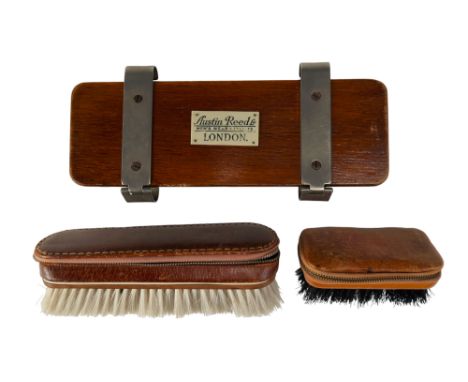 A group of vintage travel/dressing accessories, comprising an Austin Reed Ltd tie press by Watts, and two brushes with leathe
