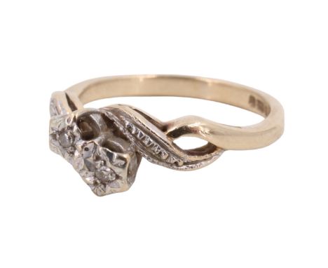 A 1990s twist-set two-stone diamond ring, the small stones illusion-set on an open interlaced double scroll shank in 9 ct gol