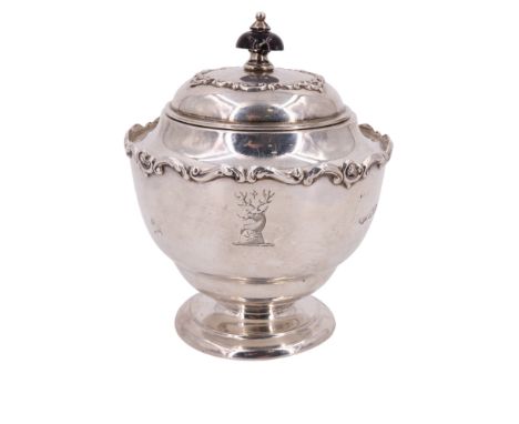An Edwardian silver tea caddy, of shouldered ovoid form and having a hinged cover and applied scrolling decoration, gilt inte