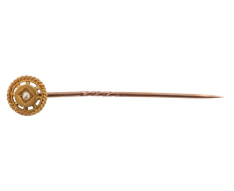 A cased early 20th Century seed pearl set stick pin, the central roundel surrounded by a cabled annulus held by pellets, mark