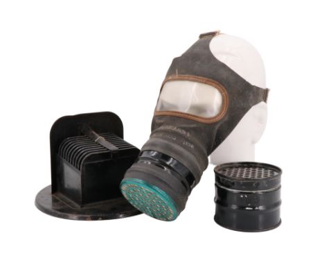 A Second World War Home Front car headlamp blackout cowl together with a civilian gas mask and spare filter canister