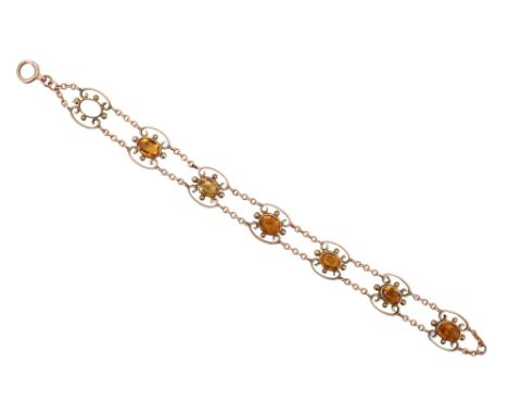 An Edwardian citrine bracelet, comprising seven oval stones of approximately 8 x 6 mm, each bezel set and surrounded by four 