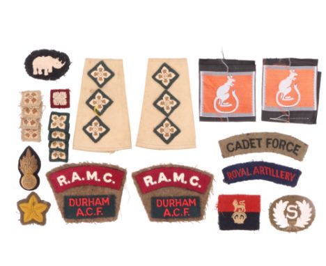 A small quantity of British army cloth insignia including a pair of Intelligence Corps officer's tropical slip-on shoulder ra