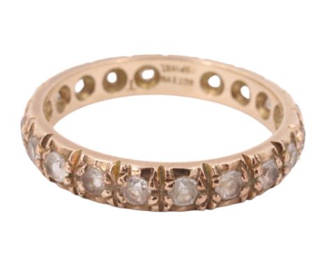 A late 20th Century white spinel eternity ring, set with 20 2 mm brilliants in a 9 ct yellow metal band, 2.20 g, size O