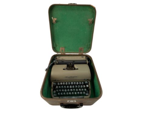 A vintage Remington Quiet-Riter typewriter in a hard shell case