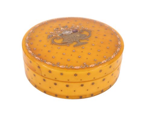 A late 18th Century French circular yellow horn snuff box, the top decorated in piqué work with different tones of inlaid gil