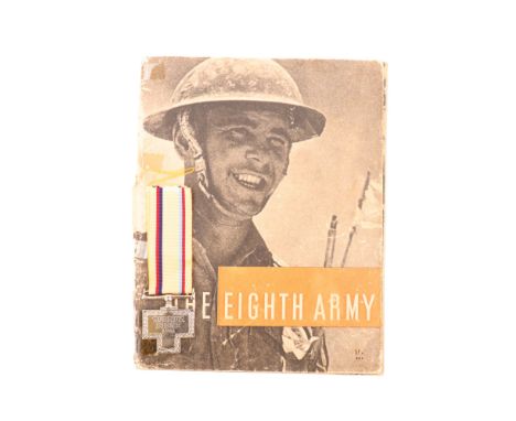 A Tobruk Siege Medal together with an annotated copy of "The Eighth Army", HMSO