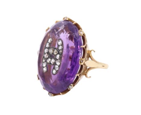 [ Channel ] A striking Belle Epoque amethyst and diamond dress ring, comprising a large oval cut amethyst (27 mm a 21 mm), it