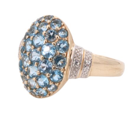 A contemporary blue spinel and white stone dress ring, having a convex oval face pave set with 29 graduated brilliants betwee