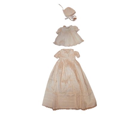 A vintage christening gown, decorated with faux seed pearls, together with a similar Sarah Louise dress