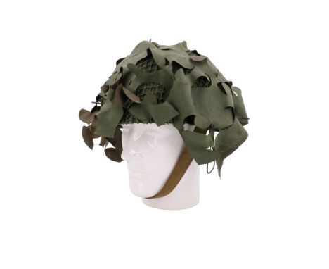 A 1950s British army Royal Armoured Corps steel helmet with camouflage net and scrim