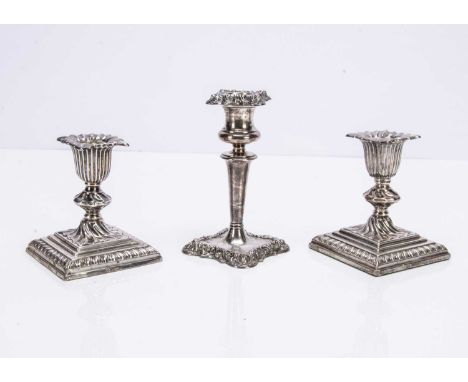 A pair of Victorian silver filled short candlesticks, together with another taller single candlestick, 13cm high (3)