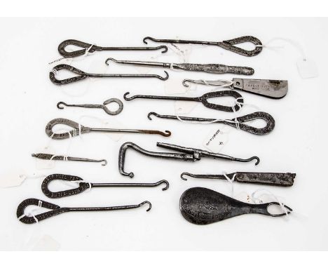 Fifteen Victorian and later Advertising and Retailers metal button hooks and shoe horns