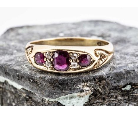 A seven stone ruby and diamond dress ring, the three cushion cut rubies alternately set with old cut diamonds within an oval 