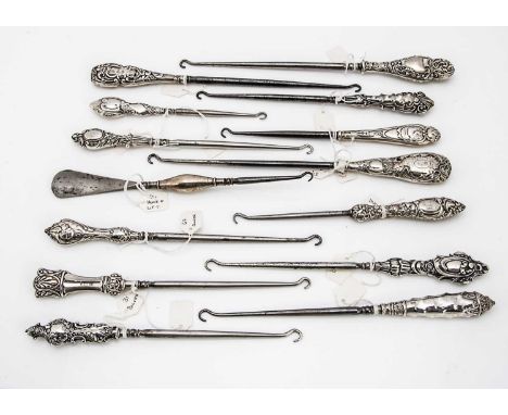 A collection of Victorian and later silver handled button hooks, various designs, most hallmarked, approx 14, one with button